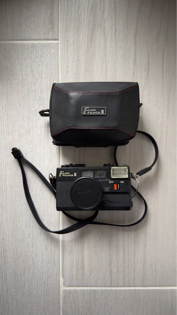 Fujica Flash Fujica II Camera (Category: Cameras) located in Pasig City. Submitted by otherwiseorchid (Listing ID 1395423435, Image 3). Description: Fujica Flash Fujica II camera with Fujinon 38mm lens. Includes lens cap, case, and strap. Built-in flash. Black. Working or not working; Offered as is. Was never used but bought as is to display..