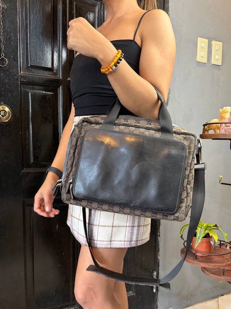 Gucci GG Canvas Business Bag (Category: Luxury Bags & Wallets) located in Baguio. Submitted by BagstacularbyJCT (Listing ID 1395352857, Image 3). Description: This Gucci Briefcase bag features a canvas body in signature GG monogram with leather trim, leather top handles, and brass hardware. The exterior features on leather-face pocket which opens through a zipper. The Interior features two spacious compartments with pockets for organization. This