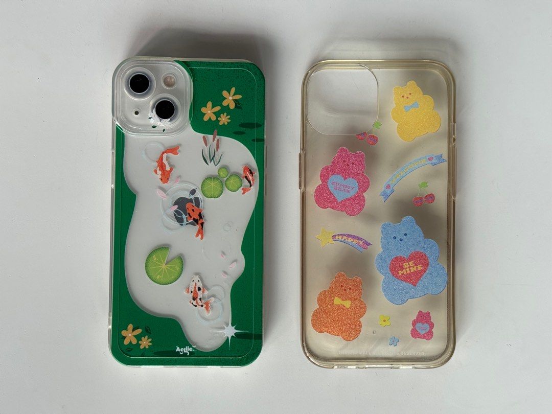 iPhone 13 Clear Phone Cases - earpearp & aellie (Category: Cases & Sleeves) located in Quezon City. Submitted by maejichoco (Listing ID 1395443214, Image 2). Description: ₱250 SET for both! earpearp bear iphone 13 case (korean brand) - well used so pls manage expectations - slightly yellowish (see pic) aellie koi fish pond iphone13 case - 8/10 condition - no yellowish stains - only used for less than a month.