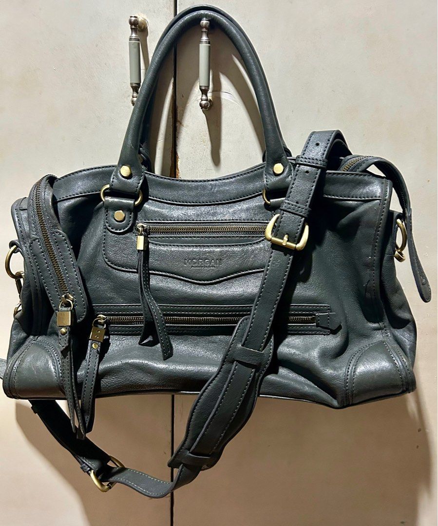 Morgan de Toi Handbag (Category: Luxury Bags & Wallets) located in Quezon City. Submitted by asiaco (Listing ID 1395437041, Image 3). Description: - Morgan de Toi handbag - Dark grey color - Top handle and detachable shoulder strap - Multiple compartments for organization - Interior lining with brand pattern - Gold-colored hardware and zipper closures.