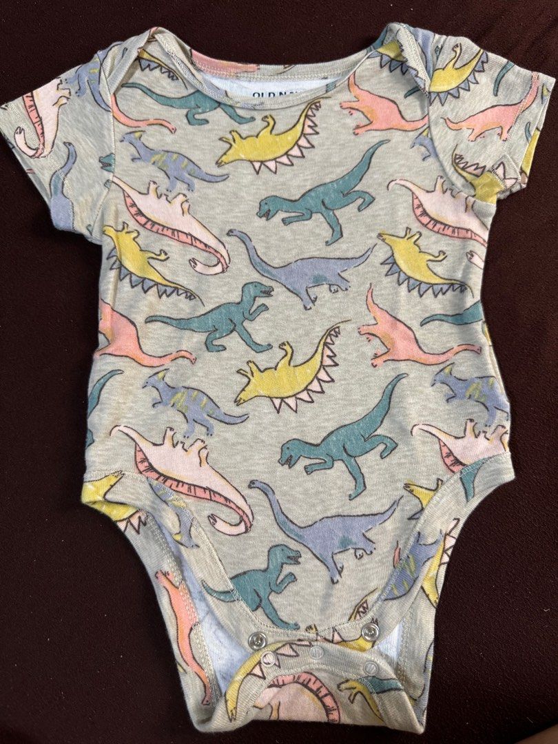 Old Navy Dinosaur Onesie 6-12M (Category: Babies & Kids Fashion) located in Manila. Submitted by geevibes (Listing ID 1395406328, Image 1). Description: - Old Navy dinosaur onesie - For babies 6-12 months - Light gray color - Features a colorful dinosaur print - Short sleeves - Snap closures for easy changes - Made in India.