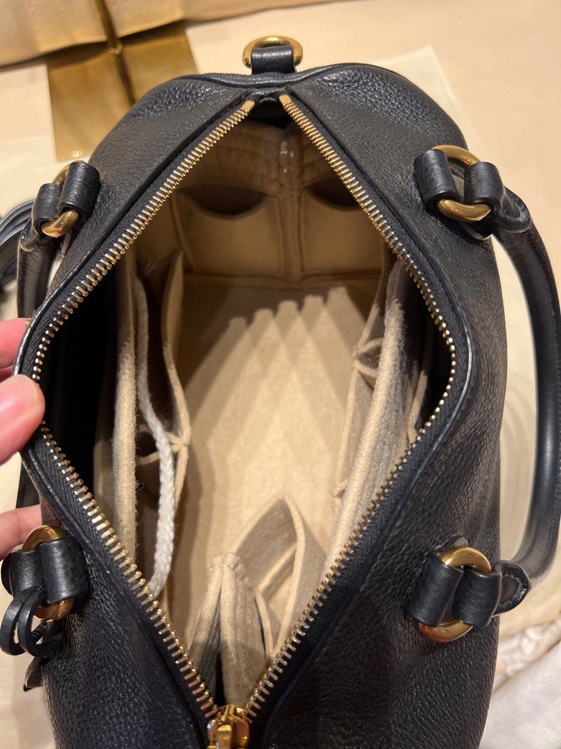 Prada Bauletto Vitello Phenix Black Handbag (Category: Luxury Bags & Wallets) located in Bacoor. Submitted by majezticos (Listing ID 1395496001, Image 2). Description: - Authentic Prada Bauletto handbag - Black Vitello Phenix leather - Gold-tone hardware - Detachable shoulder strap - Multiple interior compartments - Top zip closure - Dual top handles - Includes authenticity cards - Model number: 1BB797 DTI & BIR Registered Business Location : Bac