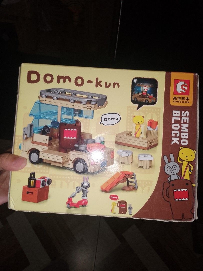 SEMBO Domo-kun Building Block Set (Category: Lego & Building Sets) located in Cainta. Submitted by mydailyell25316 (Listing ID 1395229922, Image 2). Description: - SEMBO building block set featuring Domo-kun in a van. - Includes Domo-kun figure and a yellow bear figure. - Box art shows the van with luggage..