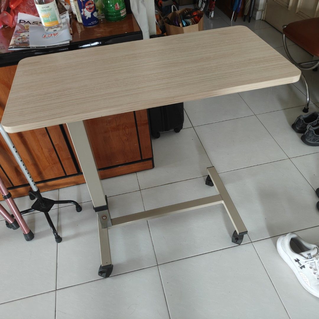Adjustable Height Bedside Rolling Table (Category: Tables & Sets) located in Singapore. Submitted by vivadeals (Listing ID 1390415643, Image 2). Description: -Best table for serving food and having to eat in bed - Adjustable height - Mobile with wheels - Wood-grain table - Suitable for bedside use - Good condition.