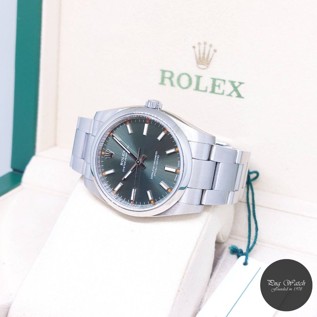 Rolex 34mm Olive Green Dial Oyster Perpetual REF: 114200 (Feb 2018) (Category: Watches) located in Singapore. Submitted by pngwatchdealer (Listing ID 1390583124, Image 2). Description: [SPECIFICATIONS] **Watch comes in full option (Box, Card & Hang Tag)** **Straight bracelet** Brand: Rolex Model: Oyster Perpetual (REF: 114200)(AN)(18)(O) Movement: Automatic (Self-Winding) Functions and Features: Hours, Minutes and Seconds (CASE) Case Material: St