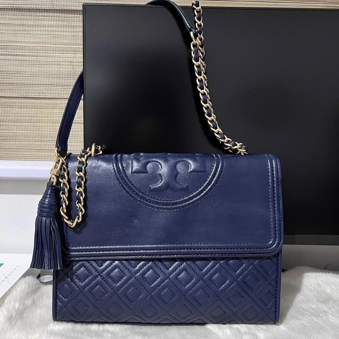 TORY BURCH Fleming dark blue with gold hardware two-way (Category: Luxury Bags & Wallets) located in Quezon City. Submitted by rmseller.2017 (Listing ID 1390438921, Image 1). Description: TORY BURCH Fleming dark blue with gold hardware two-way | medium | comes with generic dustbag | P9500 only (open for installment).