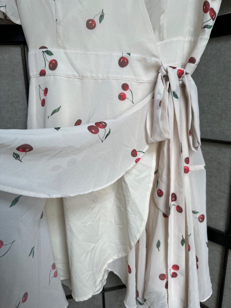 Cherry Print Wrap Dress (Category: Dresses) located in Manila. Submitted by echrise (Listing ID 1395569343, Image 3). Description: - Cherry print wrap dress - Short sleeves - Tie waist closure - V-neckline - Flowing, ruffled hem - Lightweight fabric - Versatile for various occasions -chiffon with inner lining Bust - 36” Length - 35”.