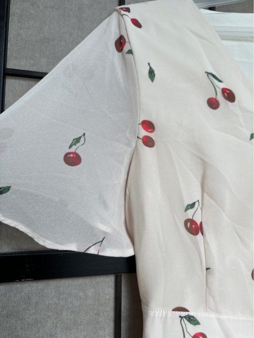 Cherry Print Wrap Dress (Category: Dresses) located in Manila. Submitted by echrise (Listing ID 1395569343, Image 2). Description: - Cherry print wrap dress - Short sleeves - Tie waist closure - V-neckline - Flowing, ruffled hem - Lightweight fabric - Versatile for various occasions -chiffon with inner lining Bust - 36” Length - 35”.