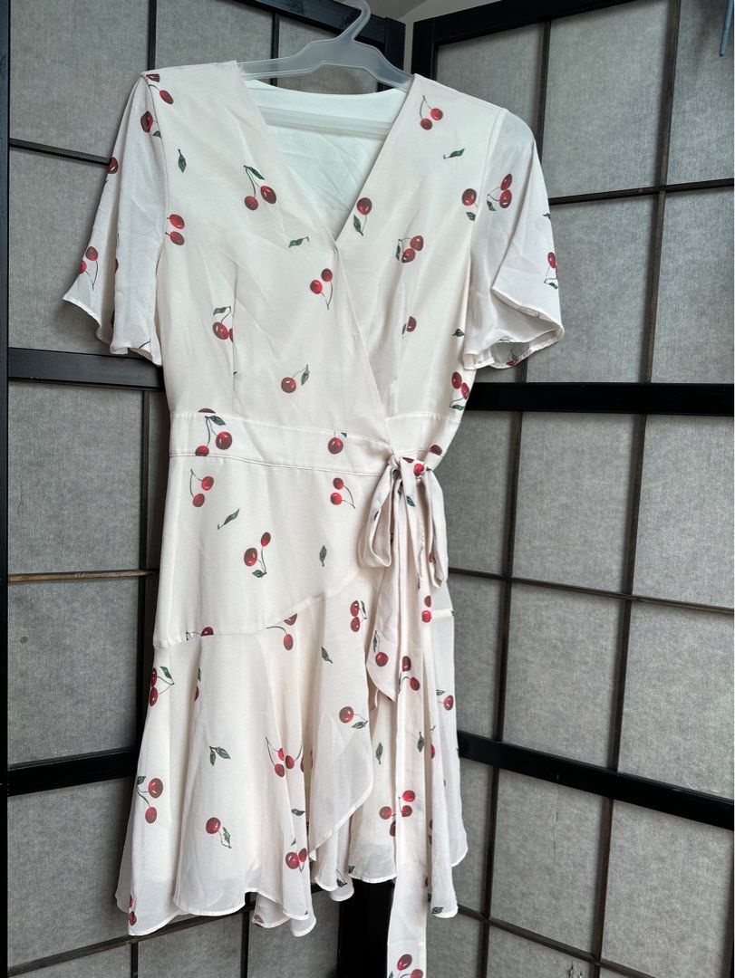 Cherry Print Wrap Dress (Category: Dresses) located in Manila. Submitted by echrise (Listing ID 1395569343, Image 1). Description: - Cherry print wrap dress - Short sleeves - Tie waist closure - V-neckline - Flowing, ruffled hem - Lightweight fabric - Versatile for various occasions -chiffon with inner lining Bust - 36” Length - 35”.
