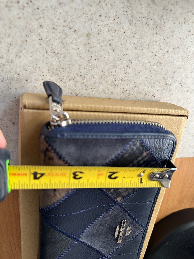 Coach Patchwork Zip Around Wallet (Category: Wallets & Card holders) located in Quezon City. Submitted by gintofinds (Listing ID 1395619492, Image 2). Description: - Authentic Coach wallet - Zip-around closure - Patchwork design with mixed textures and colors - Navy blue color - Silver hardware - Interior: Multiple card slots and zippered compartment - Made in Vietnam ✨ Condition: 7/10 📸 Dimensions & any minor flaws are shown in the photos (plea