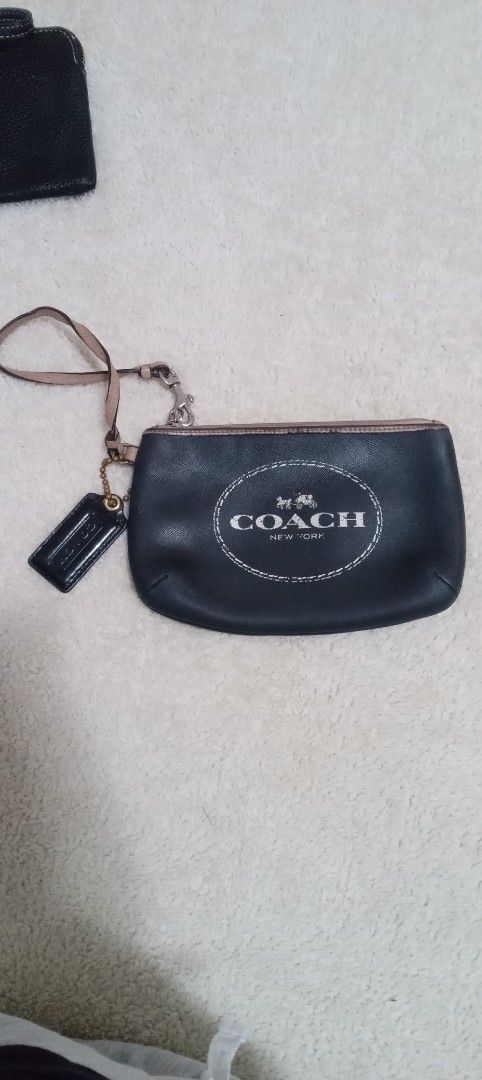 Coach Wristlet (Category: Luxury Bags & Wallets) located in San Fernando. Submitted by rizdgr (Listing ID 1395540058, Image 1). Description: Black Coach wristlet with a wrist strap and a small tag. The Coach logo is visible on the front. It has a zipper closure..