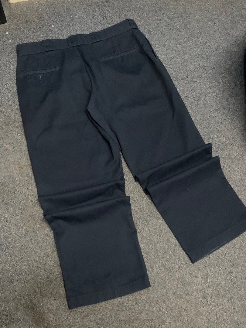 Dickies 874 Navy Blue Pants (Category: Trousers) located in Manila. Submitted by cxfer (Listing ID 1395666490, Image 3). Description: Dickies 874 navy blue pants. Features a classic straight-leg fit. Made with a blend of 65% polyester and 35% cotton. The tag indicates the pants are machine washable. The pants have a button and zipper closure. DICKIES 874 NAVY BLUE PANTS L - 39 W - 36 Thigh - 12 Hem - 9.5 VERY GOOD CONDITION NO ISSUE THRIFTED FROM