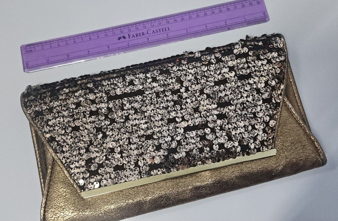 Dorothy Perkins Sequin Clutch Bag (Category: Clutches) located in Manila. Submitted by ivyfcb (Listing ID 1395572125, Image 1). Description: - Dorothy Perkins clutch bag - Gold-tone exterior - Sequin detailing on flap - Zipper closure - Black interior - Perfect for special occasions.