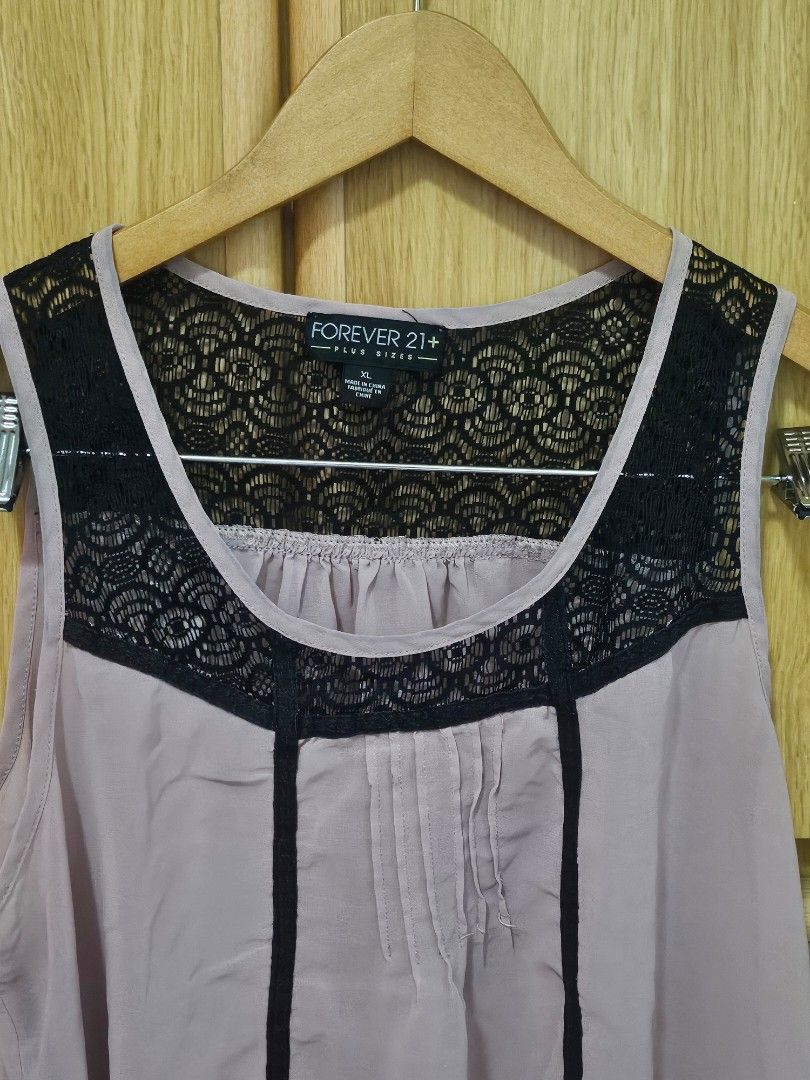 Forever 21+ Lace Trim Top XL (Category: Sleeveless) located in Quezon City. Submitted by mlr19 (Listing ID 1395680116, Image 3). Description: - Forever 21+ top - Size: XL - Color: Light pink with black lace trim - Design: Sleeveless - Features: Lace trim on neckline and back - Material: Lightweight - Style: Flattering silhouette - Perfect for various occasions.