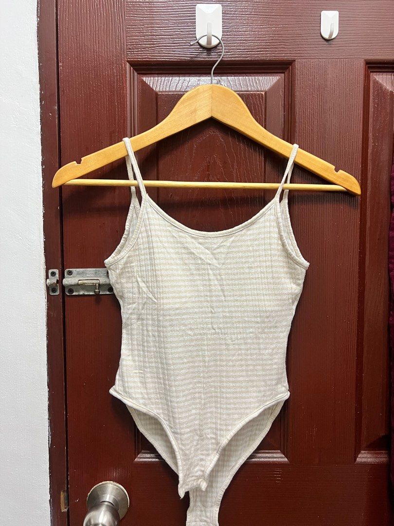 Glassons Ribbed Bodysuit XS (Category: Sleeveless) located in Quezon City. Submitted by declutteringpeppers (Listing ID 1395665868, Image 1). Description: - Glassons bodysuit - Size: XS - Color: Neutral beige - Features a ribbed texture - Design: Spaghetti straps and scoop back - Closure: Snap closure at the bottom.