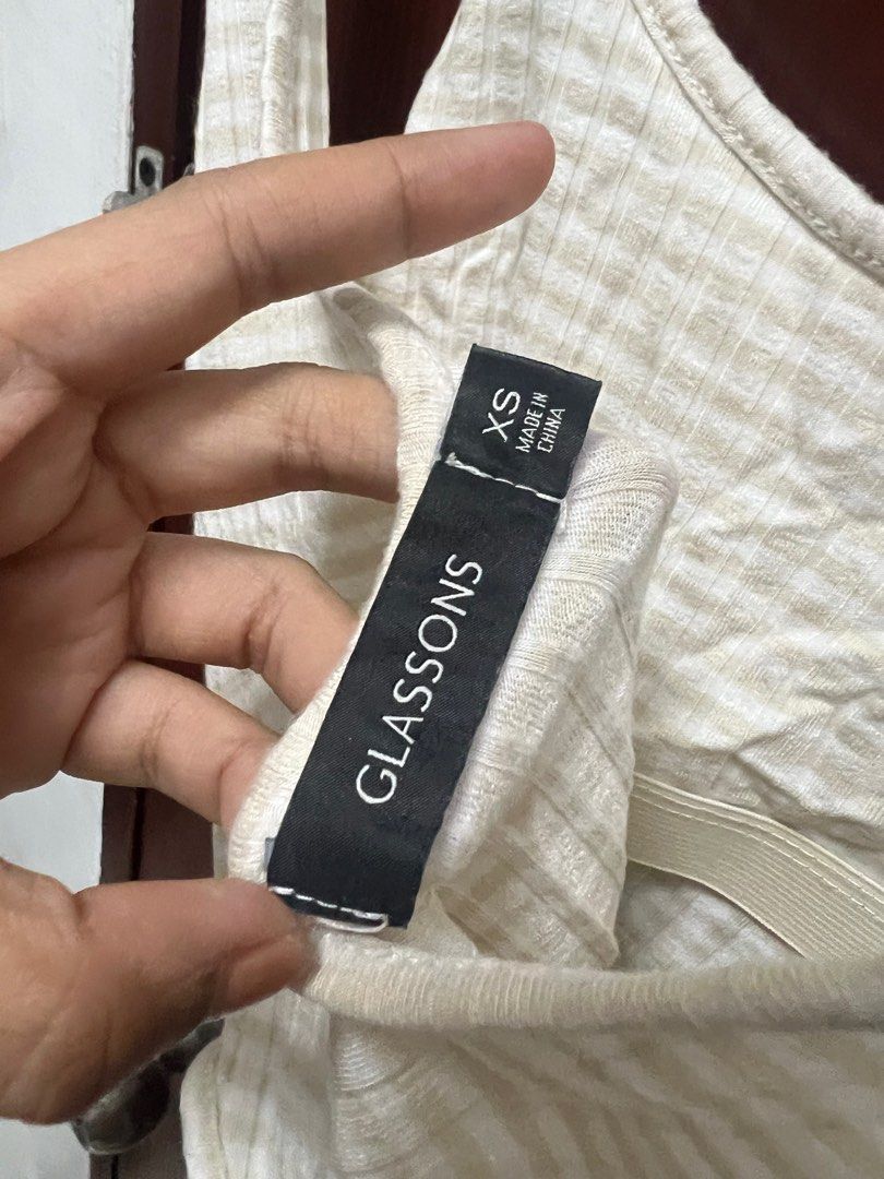 Glassons Ribbed Bodysuit XS (Category: Sleeveless) located in Quezon City. Submitted by declutteringpeppers (Listing ID 1395665868, Image 2). Description: - Glassons bodysuit - Size: XS - Color: Neutral beige - Features a ribbed texture - Design: Spaghetti straps and scoop back - Closure: Snap closure at the bottom.