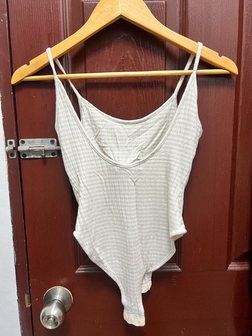 Glassons Ribbed Bodysuit XS (Category: Sleeveless) located in Quezon City. Submitted by declutteringpeppers (Listing ID 1395665868, Image 3). Description: - Glassons bodysuit - Size: XS - Color: Neutral beige - Features a ribbed texture - Design: Spaghetti straps and scoop back - Closure: Snap closure at the bottom.