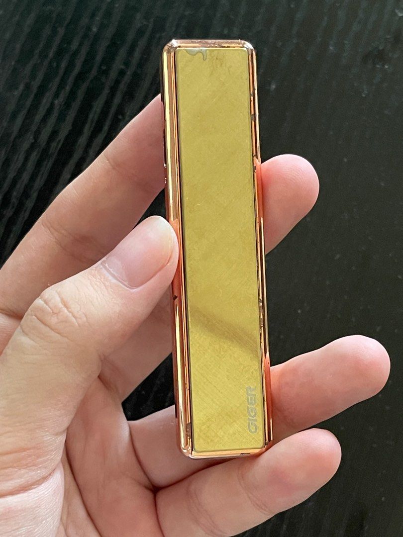 Gold Windproof Lighter (Rechargeable) - GIGER Slider Lighter (Category: Everything Else Others) located in Las Pinas. Submitted by salt.ofthe.earth (Listing ID 1395689990, Image 2). Description: - Gold GIGER USB Rechargeable Arc Slider Lighter - Windproof - Stylish design - Slim - Bought from Lighters Galore - Obvious scratches on surface but item itself was barely used - Unit only but I can try to find a charging wire for it upon request .