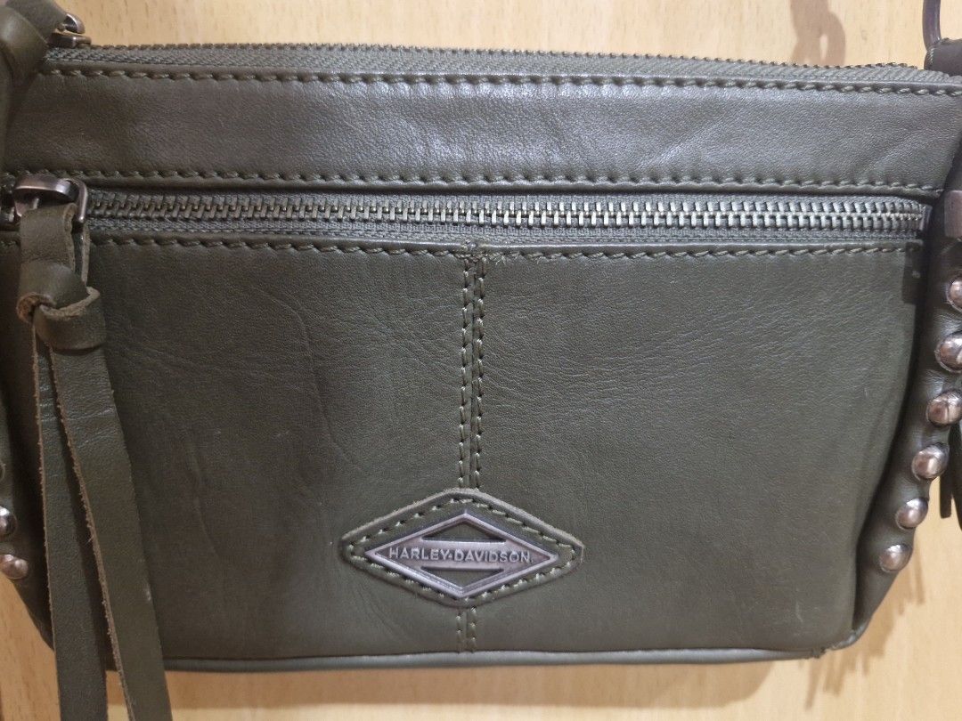 Harley-Davidson Ball & Chain Crossbody Bag (Category: Cross-body Bags) located in Muntinlupa City. Submitted by kmrod (Listing ID 1395571219, Image 3). Description: Harley-Davidson crossbody bag features a stylish design with a detachable strap zippered main compartment and an additional front pocket. adorned with metal studs and a Harley-Davidson logo charm. lined with a patterned fabric. made of genuine leather, Made in India - hard to find! be