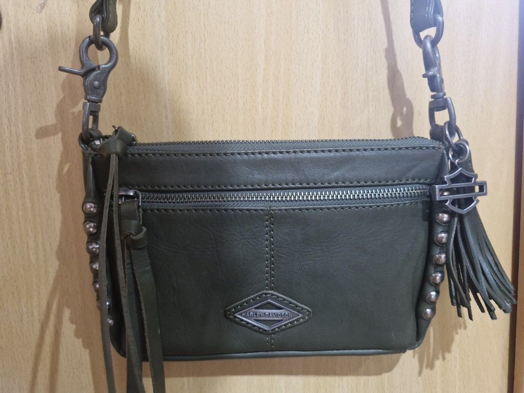 Harley-Davidson Ball & Chain Crossbody Bag (Category: Cross-body Bags) located in Muntinlupa City. Submitted by kmrod (Listing ID 1395571219, Image 2). Description: Harley-Davidson crossbody bag features a stylish design with a detachable strap zippered main compartment and an additional front pocket. adorned with metal studs and a Harley-Davidson logo charm. lined with a patterned fabric. made of genuine leather, Made in India - hard to find! be