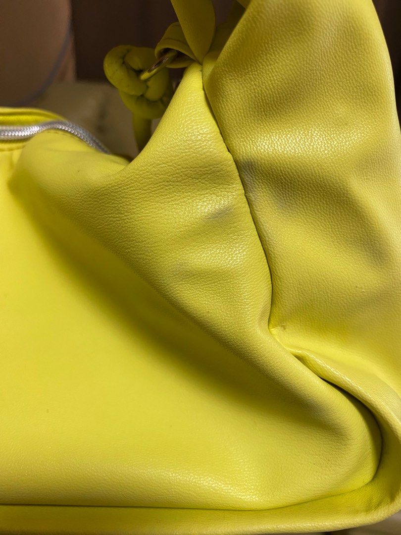 Japan Brand Yellow Twisted Handle Bag (Category: Tote Bags) located in Paranaque City. Submitted by ceceandphoebe (Listing ID 1395567959, Image 3). Description: - Stylish yellow handbag - Unique twisted handle design - Zippered closure - Soft, possibly faux leather material - Adds a pop of color to any outfit - Bought in Japan.