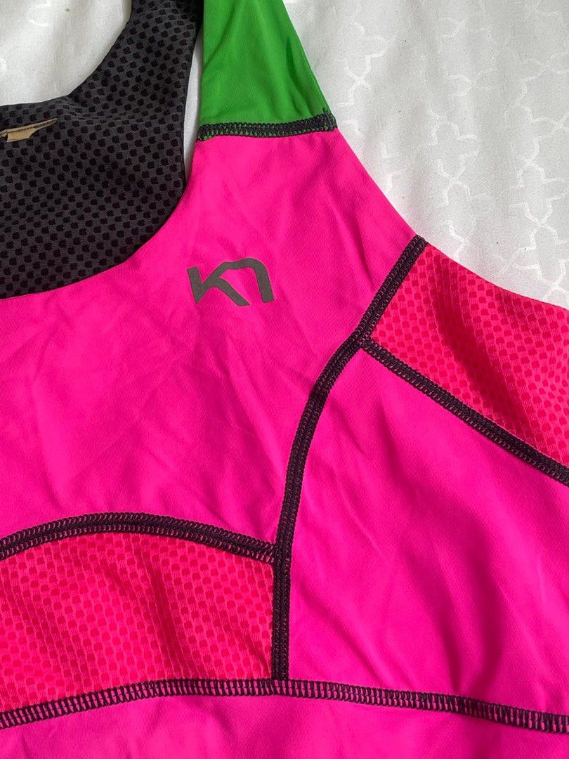 Kari Traa Tank Top (Category: Activewear) located in Las Pinas. Submitted by serialthrifter (Listing ID 1395567636, Image 3). Description: - Kari Traa tank top - Eye-catching pink color with green and black accents - Racerback design for enhanced movement - Stylish mesh detailing on front and back - Kari Traa logo visible on the back - Made from lightweight, breathable material - Perfect for workouts or everyday wear.