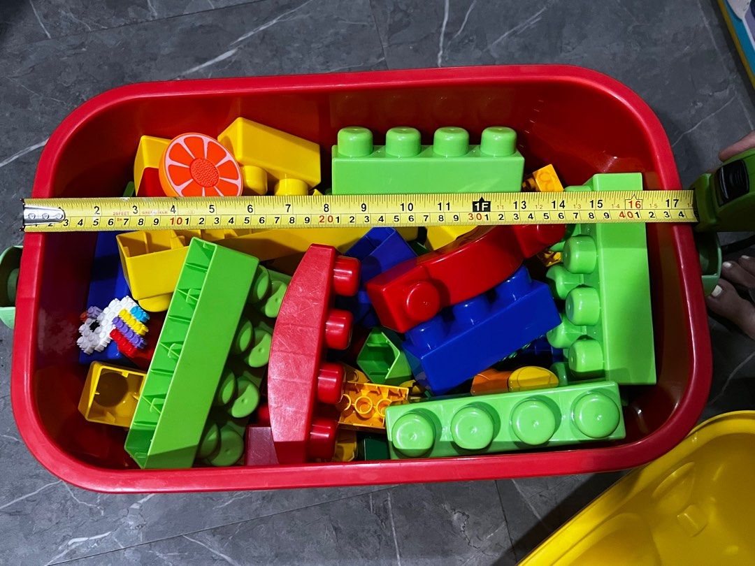 Duplo Large Building Blocks with Storage Box (Category: Lego & Building Sets) located in Quezon City. Submitted by daday39 (Listing ID 1395685827, Image 2). Description: As is po ako dito - Colorful large building blocks - Various shapes and sizes - Includes long rectangular blocks and blocks with rounded edges - Comes with a storage box - Storage box has a red base and yellow lid - Storage box has a handle for easy carrying.