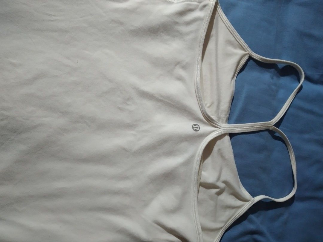 Lululemon Tank Top and Running Shorts (Category: Activewear) located in Makati City. Submitted by closet.declutterph (Listing ID 1395542897, Image 2). Description: - Lululemon athletic set - White racerback tank top - Navy blue running shorts with white trim and colorful waistband - Shorts size 4, tank top size 10 - Shorts feature a small pocket - Both items with Lululemon logo.