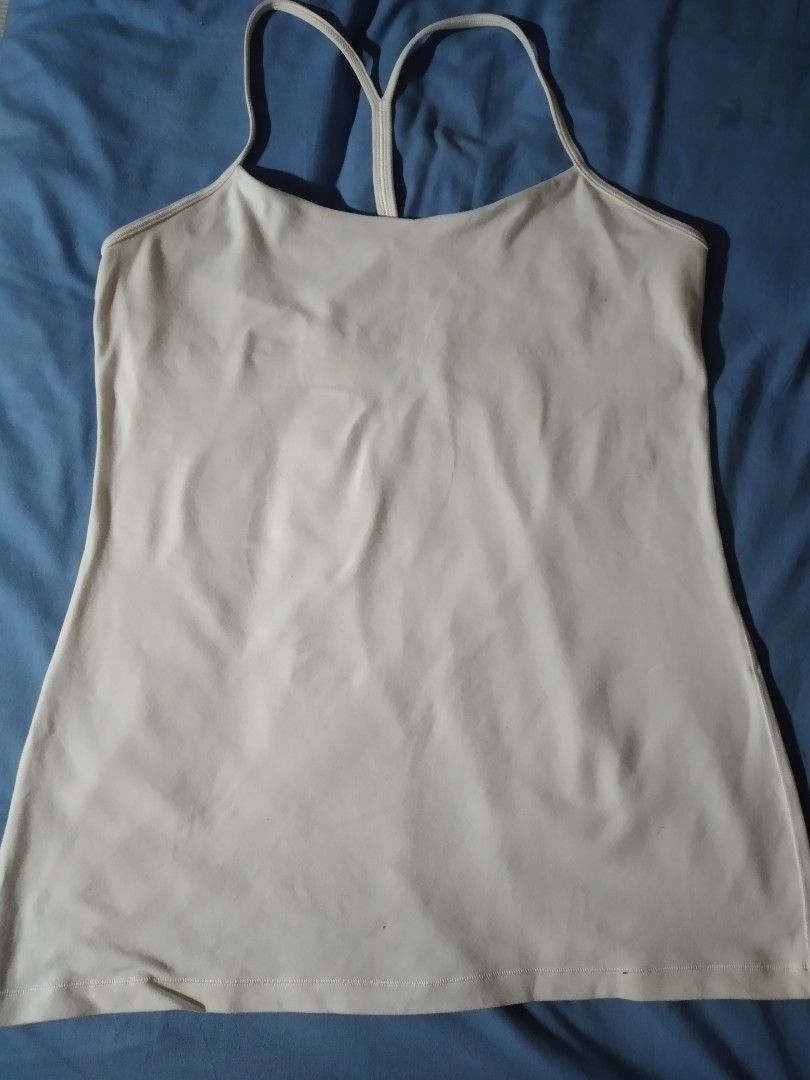 Lululemon Tank Top and Running Shorts (Category: Activewear) located in Makati City. Submitted by closet.declutterph (Listing ID 1395542897, Image 1). Description: - Lululemon athletic set - White racerback tank top - Navy blue running shorts with white trim and colorful waistband - Shorts size 4, tank top size 10 - Shorts feature a small pocket - Both items with Lululemon logo.