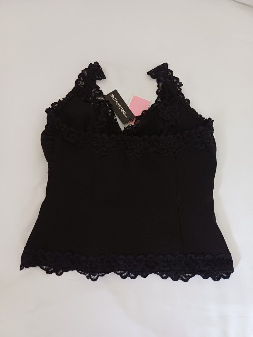 PrettyLittleThing Black Lace Trim Top (Category: Sleeveless) located in Angeles City. Submitted by dianern (Listing ID 1395570470, Image 2). Description: - PrettyLittleThing black top - Lace trim detail - Hook-and-eye closure - Fitted design - Solid black color - Brand new with tag.
