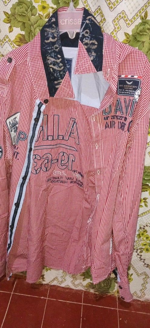 Red and White Striped Shirt (Category: Coats, Jackets and Outerwear) located in Naga. Submitted by r4e_3ftz (Listing ID 1395678154, Image 2). Description: Medium but can fit as large Still new - Red and white striped shirt - Black collar and patches - Features "A.I.R. Ea-er" text - Button-down closure - Long sleeves - Unique nautical-themed collar design - Black and white stripe down the front.