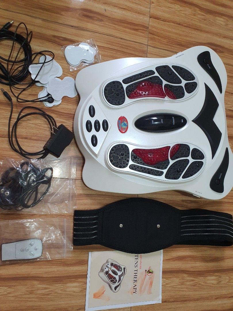 RHT TENS Therapy Foot Massager (Category: Massage Devices) located in Cavite. Submitted by heyimsosab (Listing ID 1395621379, Image 1). Description: - RHT TENS Therapy Foot Massager - Includes: Belt, Pads, Remote Control, and Instruction Manual - Features foot-shaped platforms with red accents - Provides TENS therapy - Includes diagrams of body and foot reflexology points originally nabili nasa 35k rfs: decluttering po very effective for tense mu