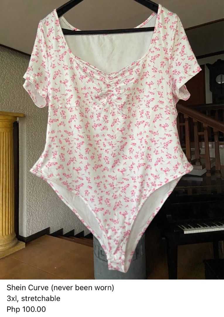 Shein Curve Floral Bodysuit (Category: Others Tops) located in Tanza. Submitted by nathsikel (Listing ID 1395553178, Image 1). Description: - Shein Curve floral bodysuit - Size: 3XL - Color: White base with pink floral print - Design: Scoop neckline, short sleeves, ruched bust detail - Features: Stretchable material - Condition: Never worn.