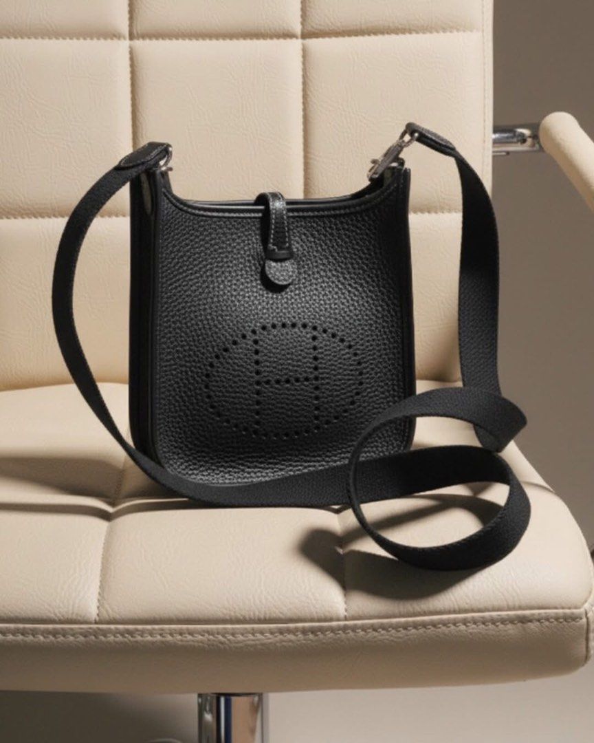 Sling Bag Mini (Category: Cross-body Bags) located in Manila. Submitted by thecluttercleaner (Listing ID 1395708160, Image 3). Description: - Sling bag ‘Evelyne’ Mini - Classic black color - Features the ‘H’ logo - Detachable black canvas shoulder strap - Includes a dust bag for storage - Secure flap closure with snap button - Pebbled leather texture ✅ Not a scammer — buy with confidence! I’m a legit seller and I value transparency. Feel free to 