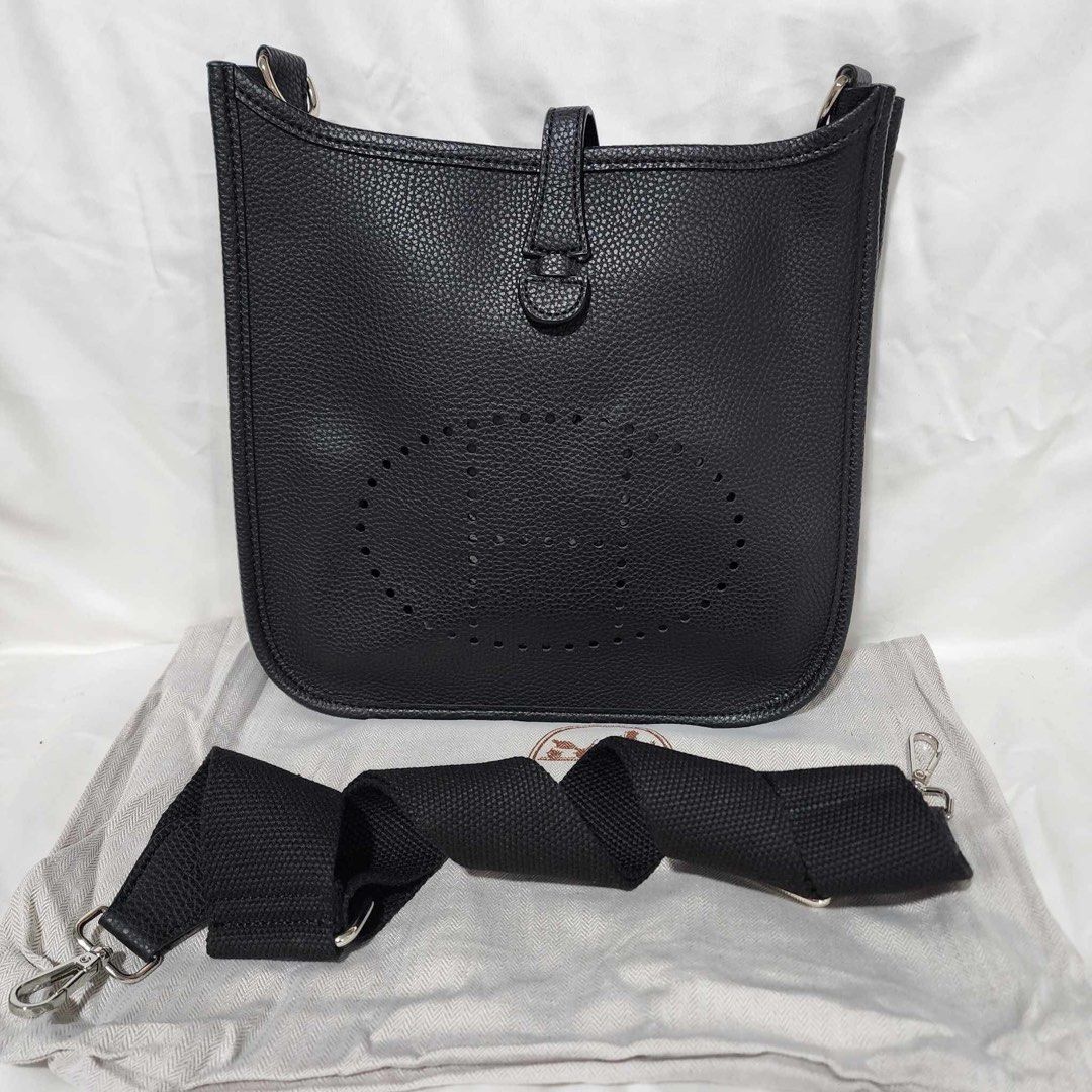 Sling Bag Mini (Category: Cross-body Bags) located in Manila. Submitted by thecluttercleaner (Listing ID 1395708160, Image 1). Description: - Sling bag ‘Evelyne’ Mini - Classic black color - Features the ‘H’ logo - Detachable black canvas shoulder strap - Includes a dust bag for storage - Secure flap closure with snap button - Pebbled leather texture ✅ Not a scammer — buy with confidence! I’m a legit seller and I value transparency. Feel free to 