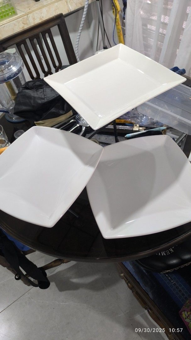 Square White Serving Plates with Metal Stands (Category: Dinnerware & Cutlery) located in Manila. Submitted by zachariesmanila (Listing ID 1395562286, Image 1). Description: - Set of 3 square white serving plates with black metal stands. - Simple and elegant design. - Ideal for appetizers, desserts, or small dishes. - Elevated presentation for parties, events, or everyday use. - Plates and stands included. 1 plate has been replaced. 2 other plate