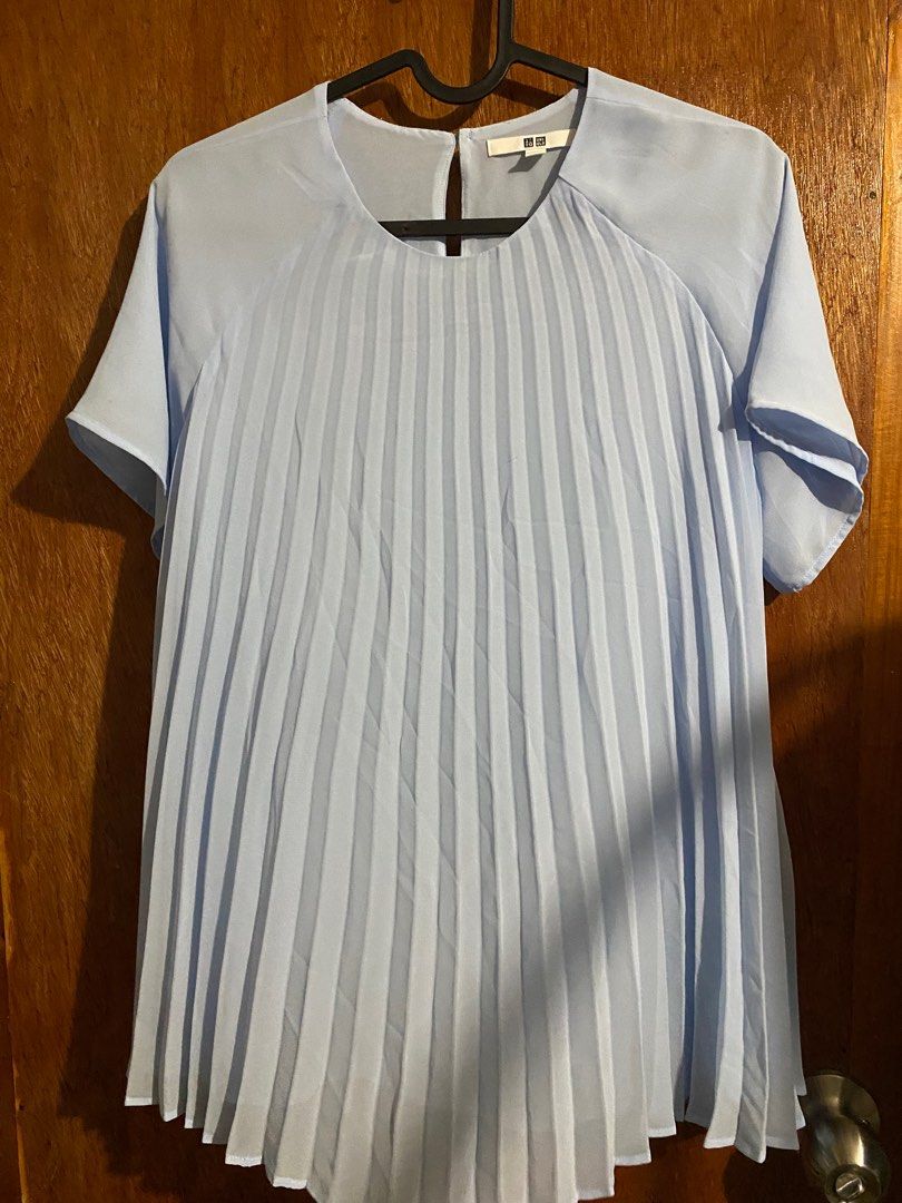 Uniqlo Pleated Top - Light Blue - Size M (Category: Blouses) located in Santa Rosa. Submitted by lesssojuplease (Listing ID 1395636428, Image 1). Description: - Uniqlo pleated top - Color: Light Blue - Size: M - Features: Round neckline, short sleeves - Material: 100% Polyester - Design: Pleated front - Closure: Button at back of neck Ship via J&T 📍Sta. Rosa.