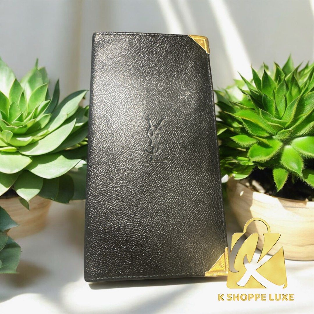 YSL Yves Saint Laurent Long Wallet (Category: Luxury Bags & Wallets) located in Malvar. Submitted by kshoppeluxe2012 (Listing ID 1395624704, Image 1). Description: - Authentic YSL long wallet - Color: Black - Iconic YSL logo - Multiple card slots and compartments - Includes card from the collection - Gold-toned corner accents - Made of leather.