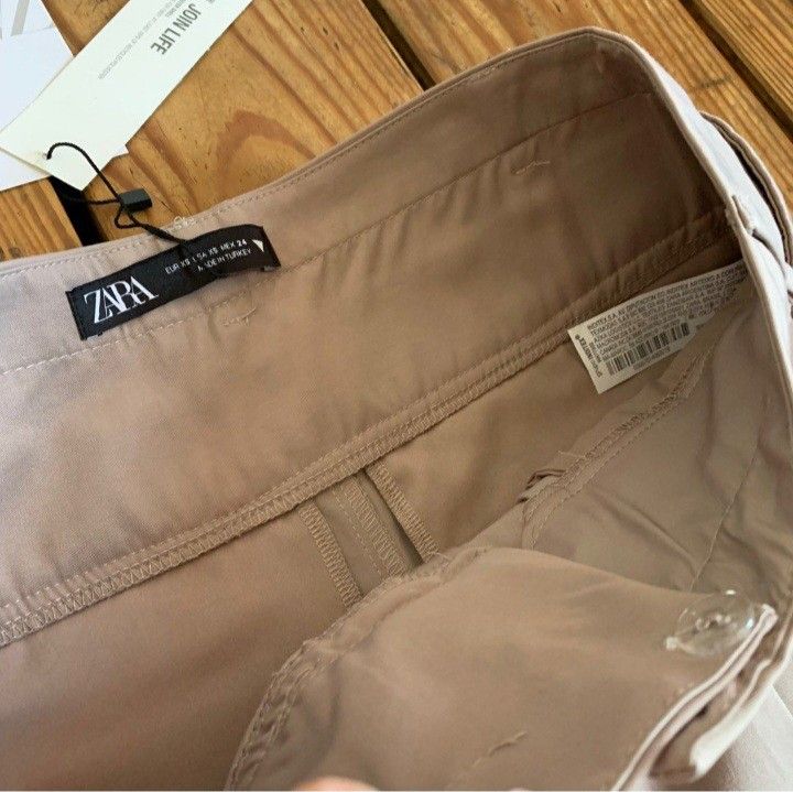 Zara double waistband trousers (Category: Other Bottoms) located in Santa Rosa. Submitted by chaneloberli.n (Listing ID 1395694344, Image 3). Description: - Beige color - Size XS - Relaxed fit - New with tags - Original price: ₱2,995.00 - Button and zipper closure - original seller had it altered -2cm at the waistband but still fits like xs zara (can be easily removed) - never used; too big for me - no ww - slightly negotiable waist: 13 in. lengt