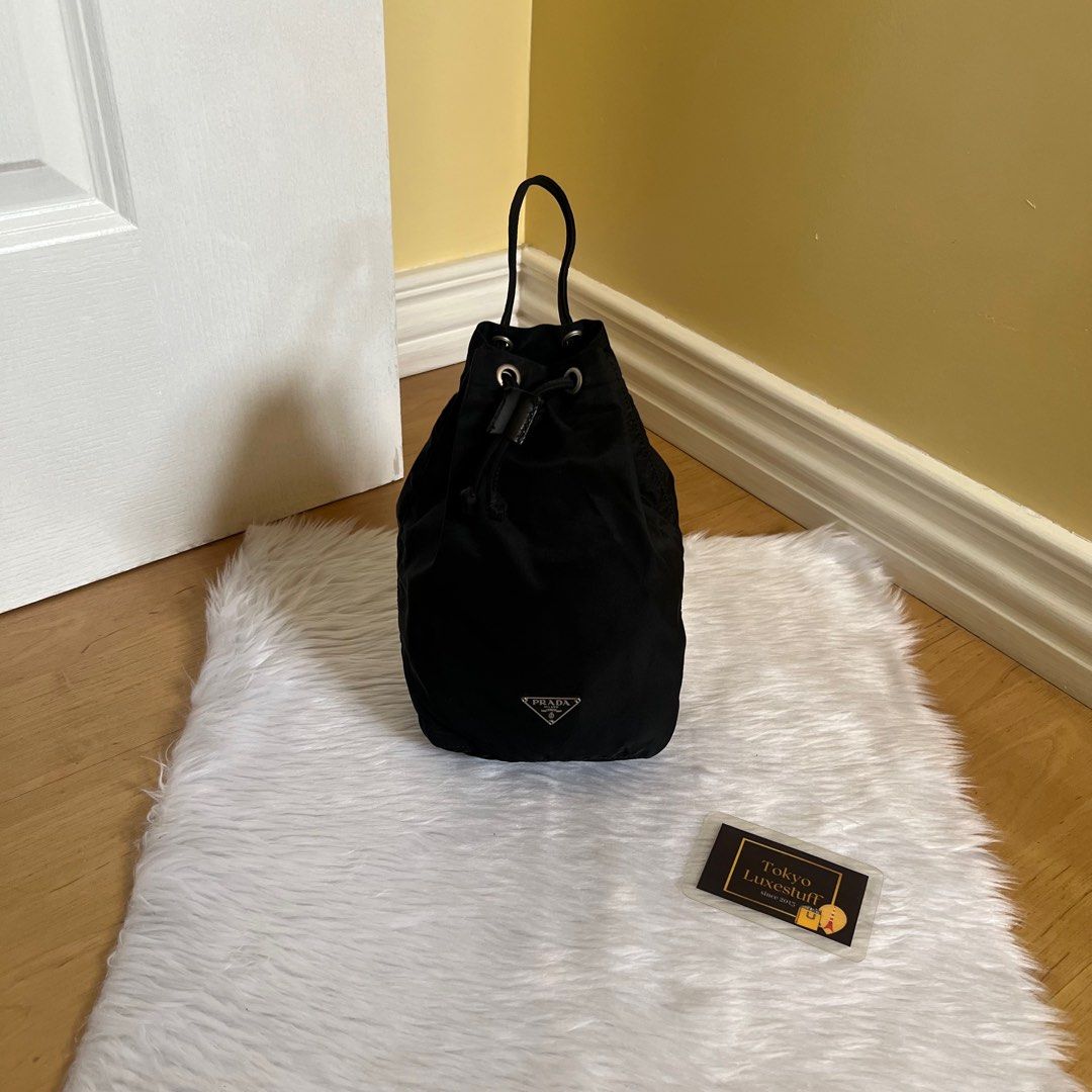 Authentic Preloved Prada Nylon Bucket Bag (Category: Luxury Bags & Wallets) located in Quezon City. Submitted by tokyoluxestuff2013 (Listing ID 1390875796, Image 1). Description: Authentic Preloved Prada Nylon Bucket Black Approx 13cm W x 22 cm H No inclusion Onhand Shipping via LBC/ Grab/ Lalamove Add shipping fee.