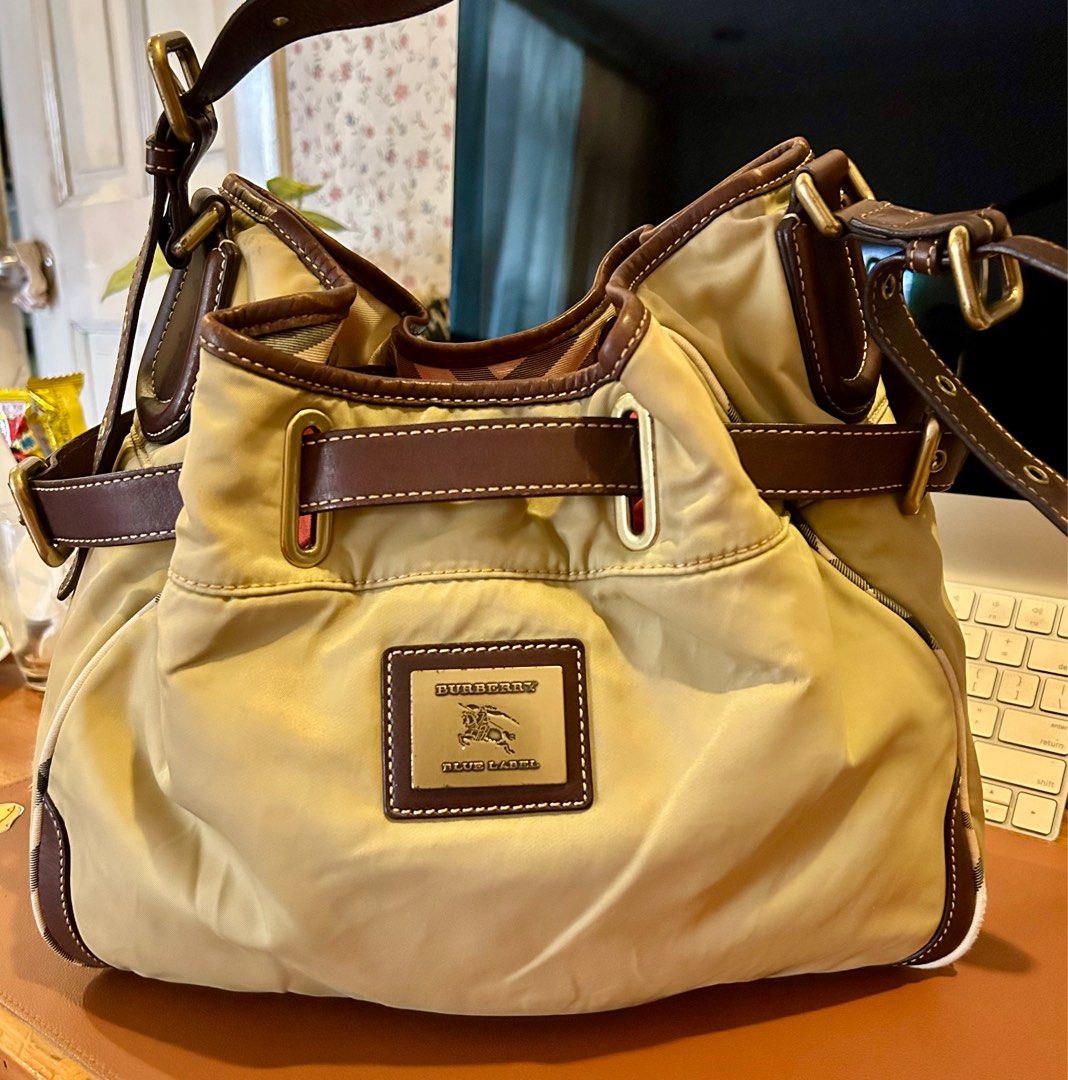 Burberry bucket/shoulder bag (Category: Luxury Bags & Wallets) located in Quezon City. Submitted by asiaco (Listing ID 1349459463, Image 1). Description: Very nice BB bucket bag. Spacious and clean. Adjustable side belts, nylon and leather combination, interior is cotton with signature bb plaid. Bucket bags are lucky money holders. This one is a blue label. .
