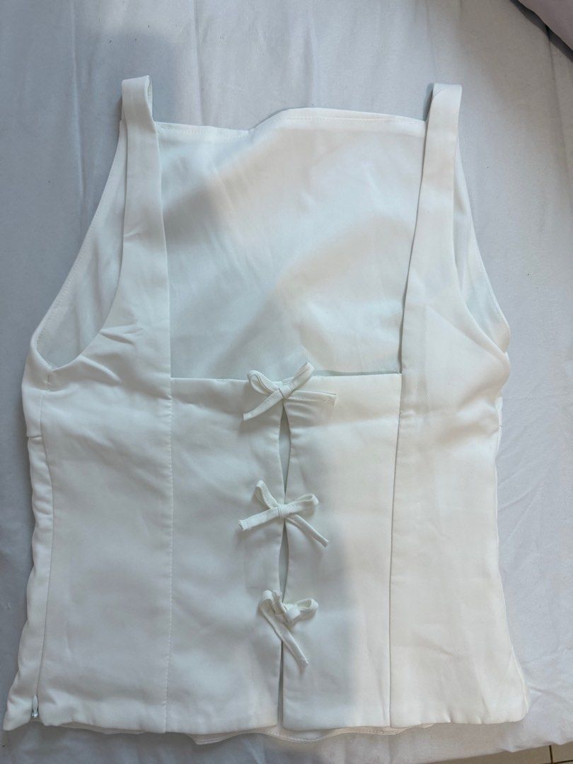 White Bow Top (Category: Blouses) located in Manila. Submitted by dalmideclutters (Listing ID 1390871544, Image 2). Description: -never used -too big on me -bought at ig: @clothesforbreakfast -flaw: check last pic.
