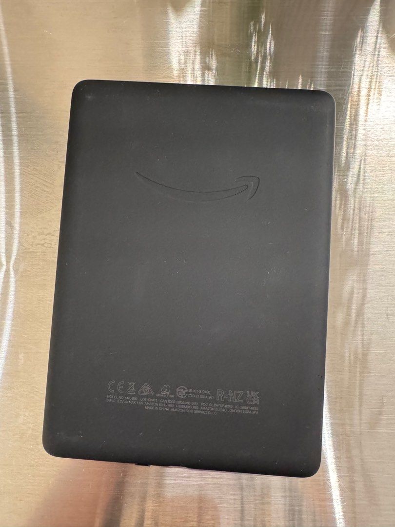 Amazon Kindle E-reader (Category: E-Readers) located in Singapore. Submitted by nespresso31 (Listing ID 1391111210, Image 1). Description: - Amazon Kindle e-reader - Good condition; barely used - Perfect for reading on the go - Clear and easy-to-read screen - Features the Amazon logo on the back.