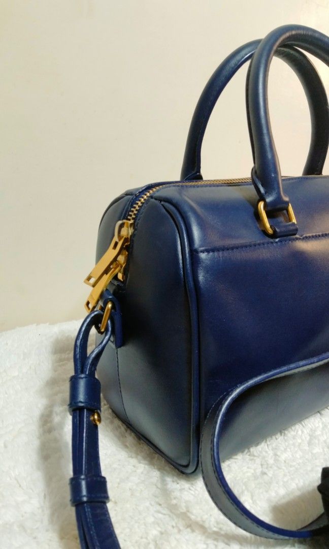 Authentic Saint Laurent (Category: Luxury Bags & Wallets) located in Dasmarinas. Submitted by derliederr63522 (Listing ID 1391076662, Image 3). Description: 🔥SAINT LAURENT PARIS Saint Laurent Baby Duffle 2WAY Handbag/Shoulder Bag Navy/Leather with bag ◆Product details SAINT LAURENT PARIS Saint Laurent Baby Duffle 2WAY Bag Color: Navy <Size> Height 13.5cm Width 22.5cm Depth 10cm (Please understand that there may be some errors as this is an amate