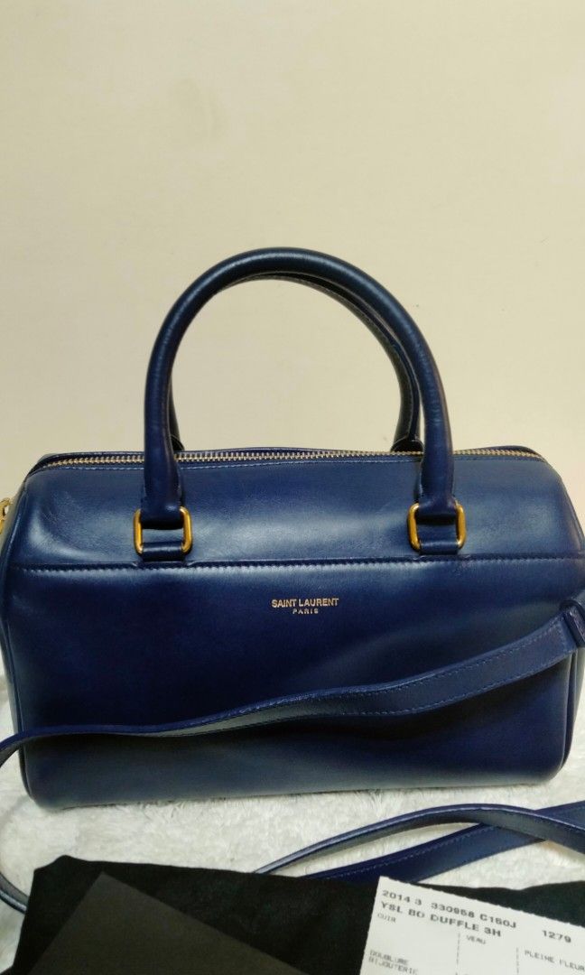 Authentic Saint Laurent (Category: Luxury Bags & Wallets) located in Dasmarinas. Submitted by derliederr63522 (Listing ID 1391076662, Image 2). Description: 🔥SAINT LAURENT PARIS Saint Laurent Baby Duffle 2WAY Handbag/Shoulder Bag Navy/Leather with bag ◆Product details SAINT LAURENT PARIS Saint Laurent Baby Duffle 2WAY Bag Color: Navy <Size> Height 13.5cm Width 22.5cm Depth 10cm (Please understand that there may be some errors as this is an amate