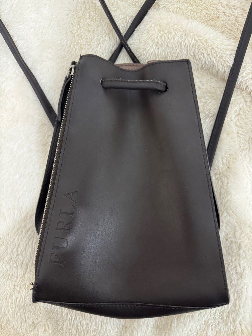 Furla mini leather backpack (Category: Luxury Bags & Wallets) located in Pasig City. Submitted by joyshares (Listing ID 1391056059, Image 1). Description: Decluttering - selling some of my pre-loved bags ❤️ Authentic Furla dark brown mini backpack *with minor sign of usage (see photos) Bought in Japan .