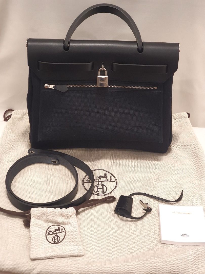 Hermes Herbag 31 Noir w Palladium Hardware (Category: Luxury Bags & Wallets) located in Las Pinas. Submitted by therealmacynn (Listing ID 1391076799, Image 1). Description: The gorgeous Hermes Herbag is a standout. Near perfect condition, she comes with the dustbag, key clochette, lock, shoulder strap, care booklet and floating inner pocket. P200k We are not affiliated, associated, authorized, endorsed by, or in any way officially connected with 