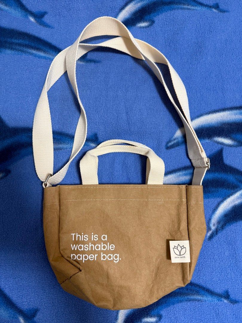 MINI SLING Tan New Earth Washable Paper Bag (Category: Cross-body Bags) located in Taguig. Submitted by _jumpingchicken (Listing ID 1391019653, Image 1). Description: rfs: decluttering Dimensions Length: 8 inches Height: 6 inches Width: 3.5 inches Sling: 24 inches maximum length Short Handle: 5 inches.
