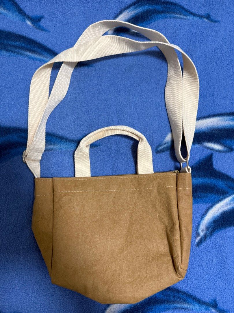 MINI SLING Tan New Earth Washable Paper Bag (Category: Cross-body Bags) located in Taguig. Submitted by _jumpingchicken (Listing ID 1391019653, Image 2). Description: rfs: decluttering Dimensions Length: 8 inches Height: 6 inches Width: 3.5 inches Sling: 24 inches maximum length Short Handle: 5 inches.