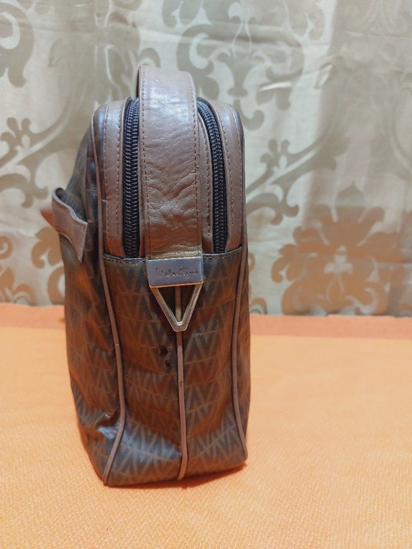Vintage m.valentino Messenger Bag (Category: Luxury Bags & Wallets) located in Muntinlupa City. Submitted by sakurambo_des (Listing ID 1391077280, Image 3). Description: Vintage Mario Valentino Messenger Bag 2 compartment Issue-light hard leather due to stock,but still in useable.No other flaws follows. Sale 500 only.